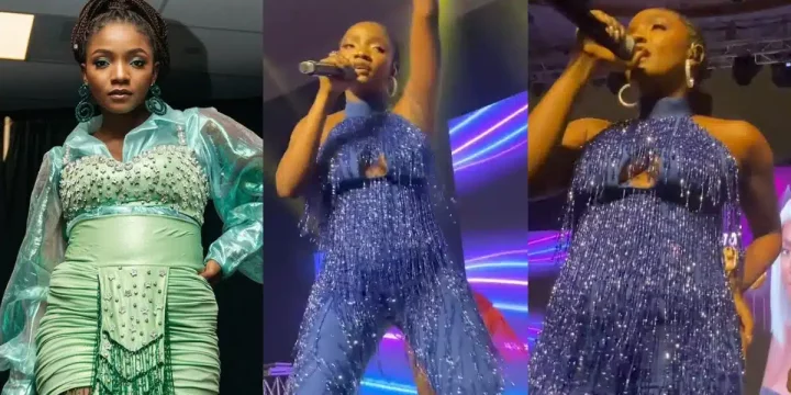 "Someone's preggy" - Pregnancy speculations circulate as Simi performs on stage in jumpsuit